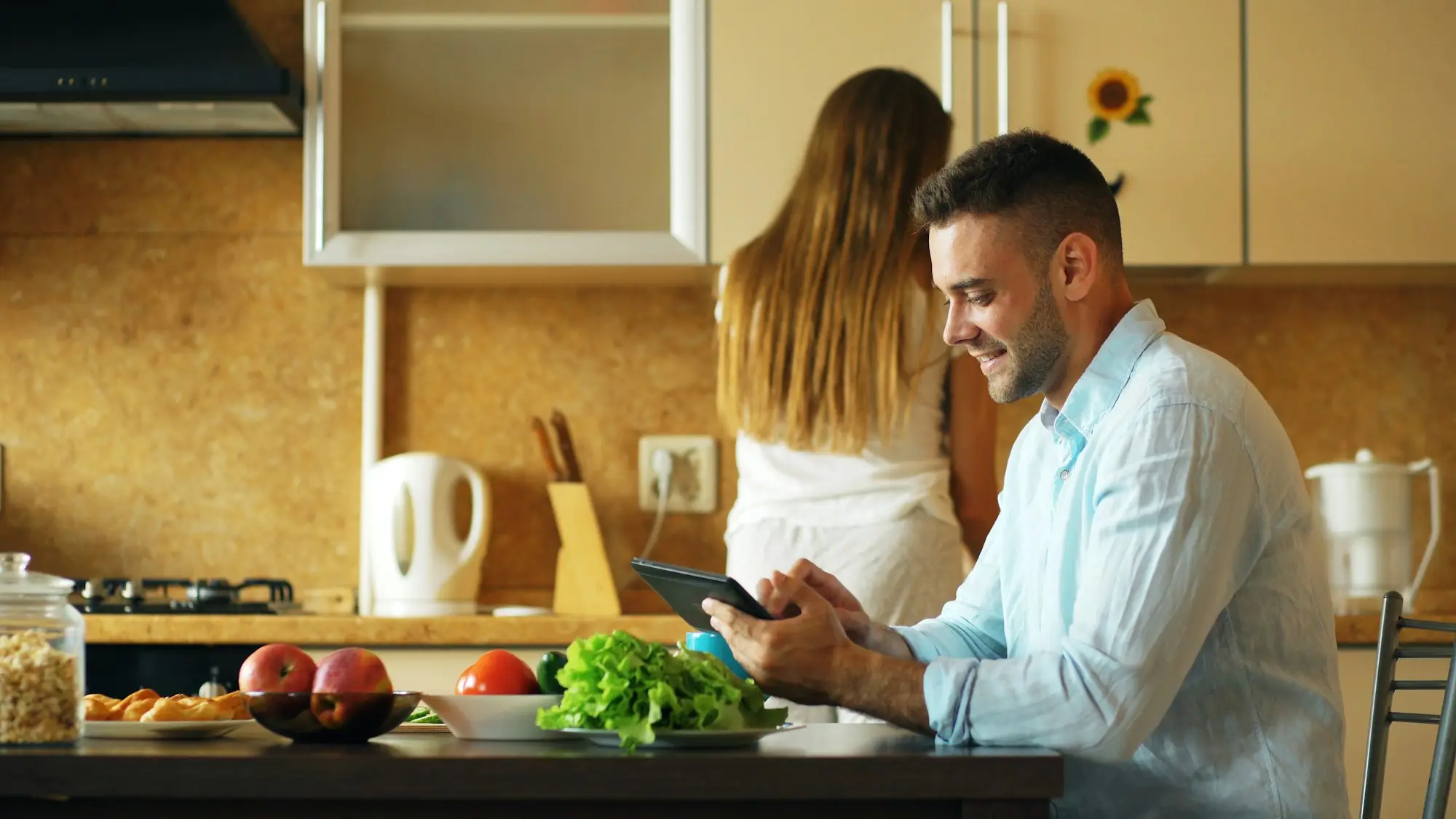Couple going through household paperwork in the kitchen