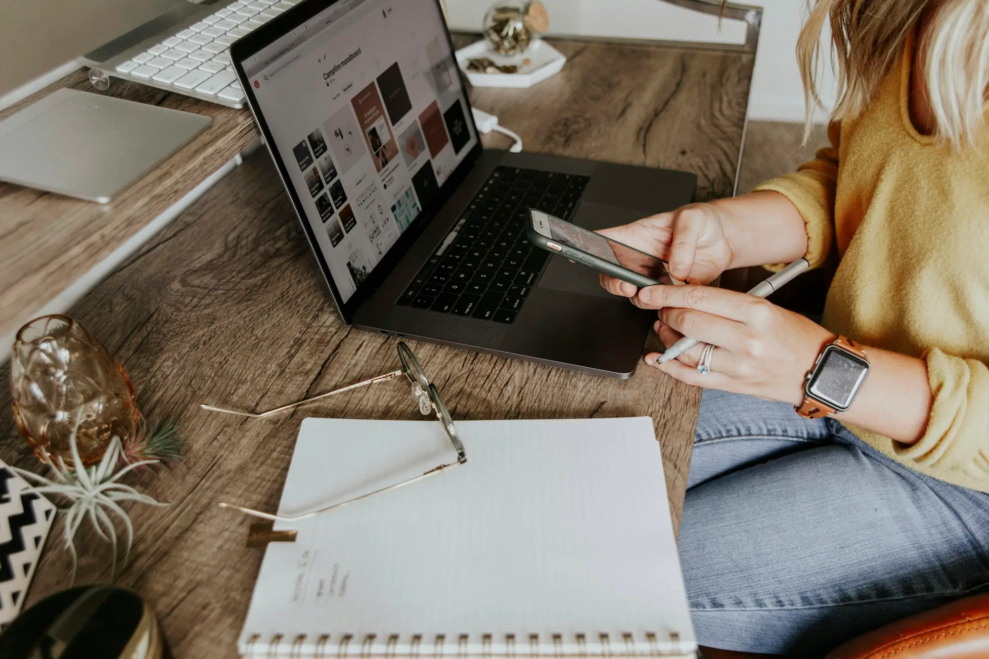 Business owner working at a laptop with paperwork